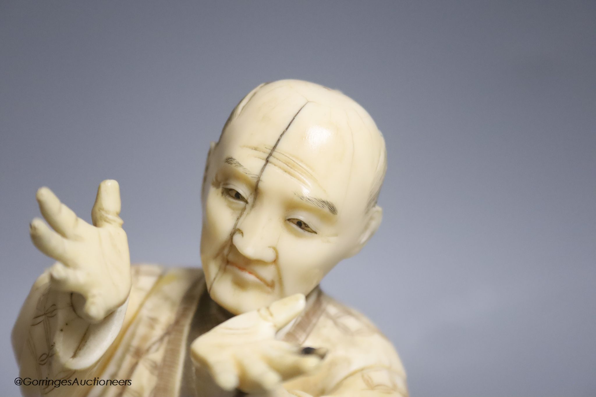 Two Japanese sectional ivory figures of farmers, early 20th century, one signed to base, height 24cm